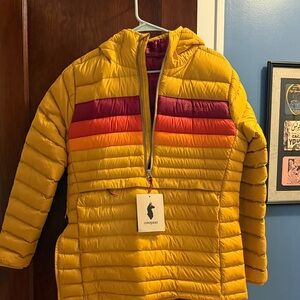 Cotopaxi Golden Jacket with Vibrant Stripes